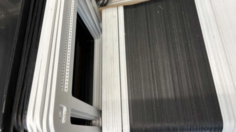 Stack of large-area electrolysis cell components with frames, prepared for stack assembly.