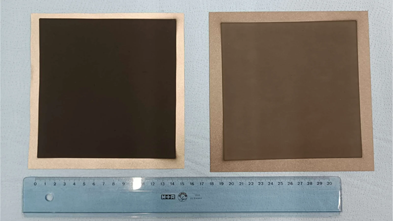 Two large-area electrolysis electrodes side by side with a ruler for scale.