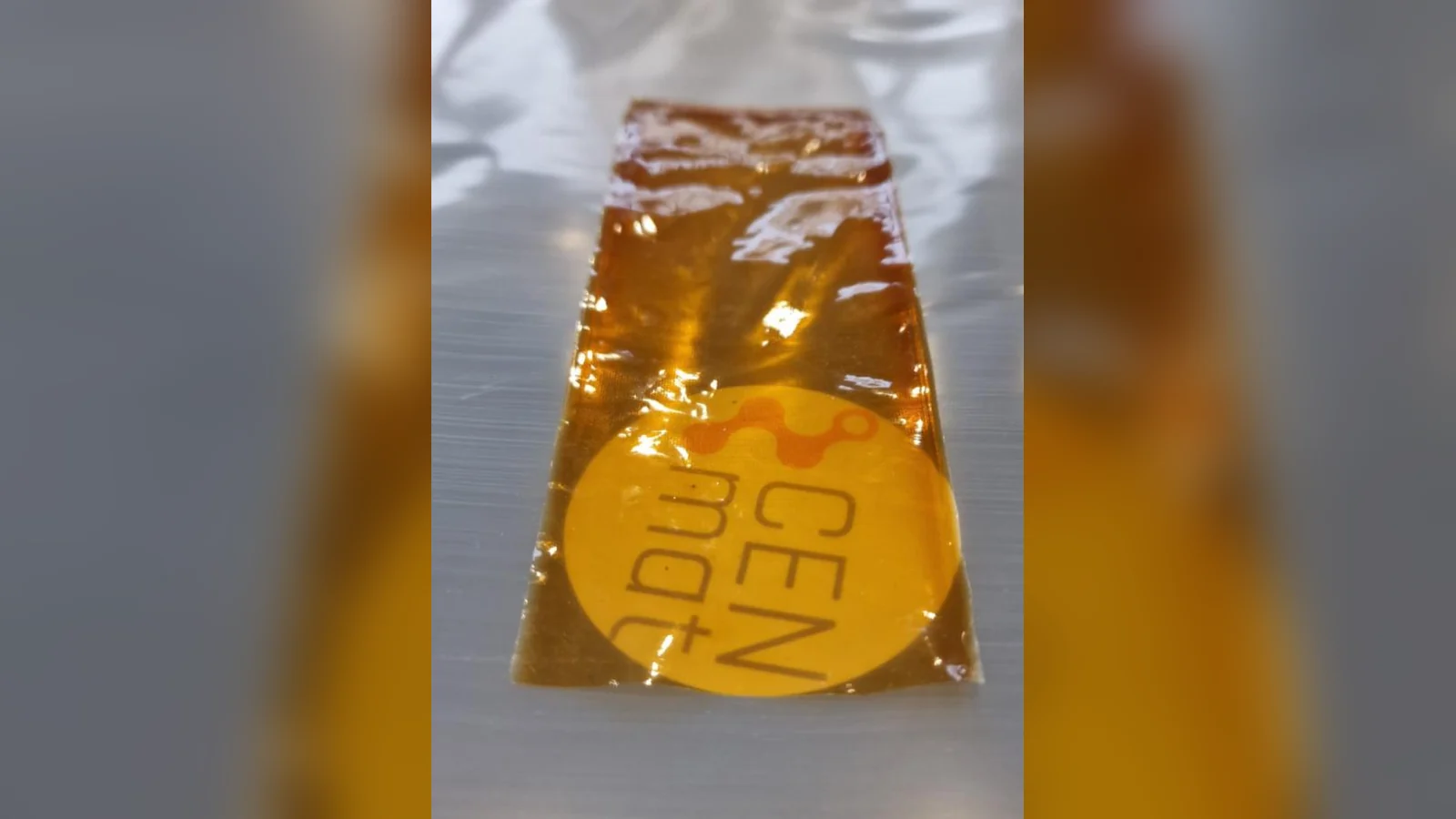 Close-up of a thin, translucent membrane sheet with the CENmat logo visible through it.