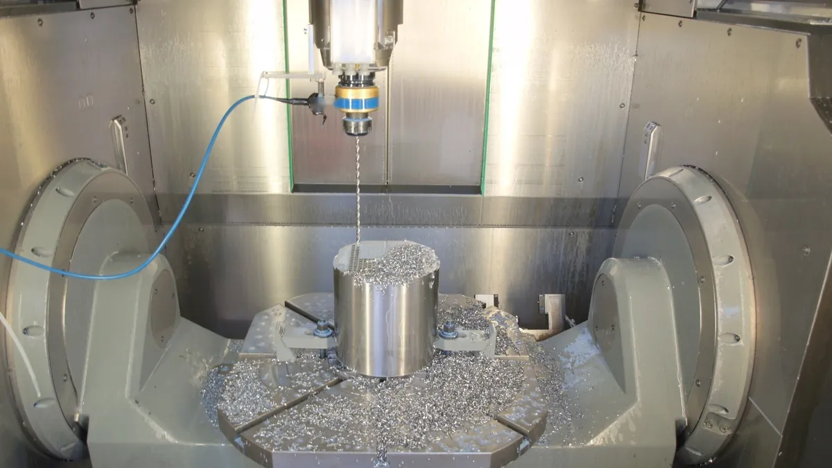 CNC machining centre drilling a precision metal part, as used for stack hardware manufacturing
