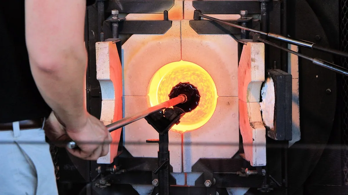 Worker at a glass-making furnace, a high-temperature process heat demand that hydrogen can supply