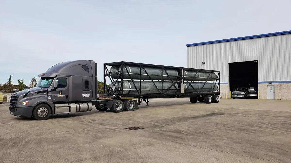 Truck with a hydrogen tube trailer at an industrial site, the delivered-hydrogen alternative to on-site electrolysis