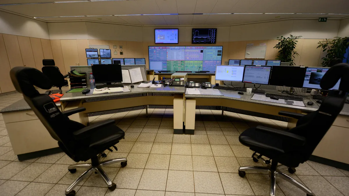 Control room of an industrial energy plant with operator desks and process monitoring screens
