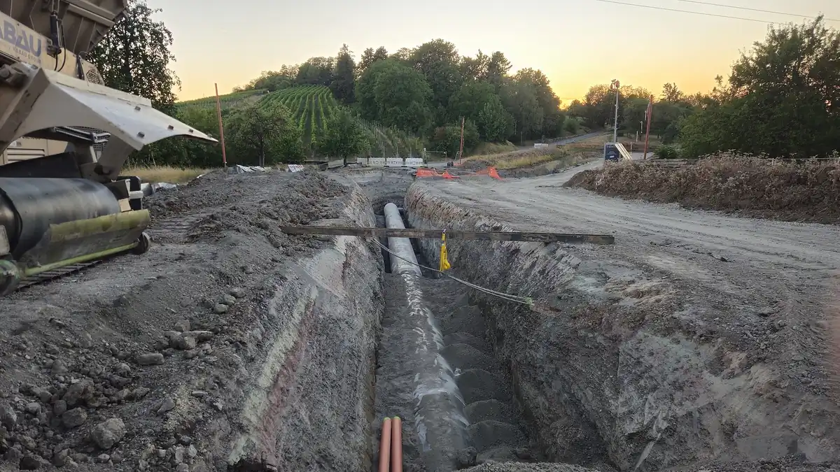 Large infrastructure construction site with an open trench, illustrating first-of-a-kind project execution risk