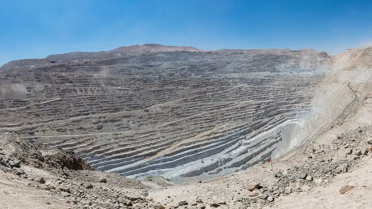Terraced open-pit mine, illustrating the mining origin of critical raw materials in electrolyser supply chains