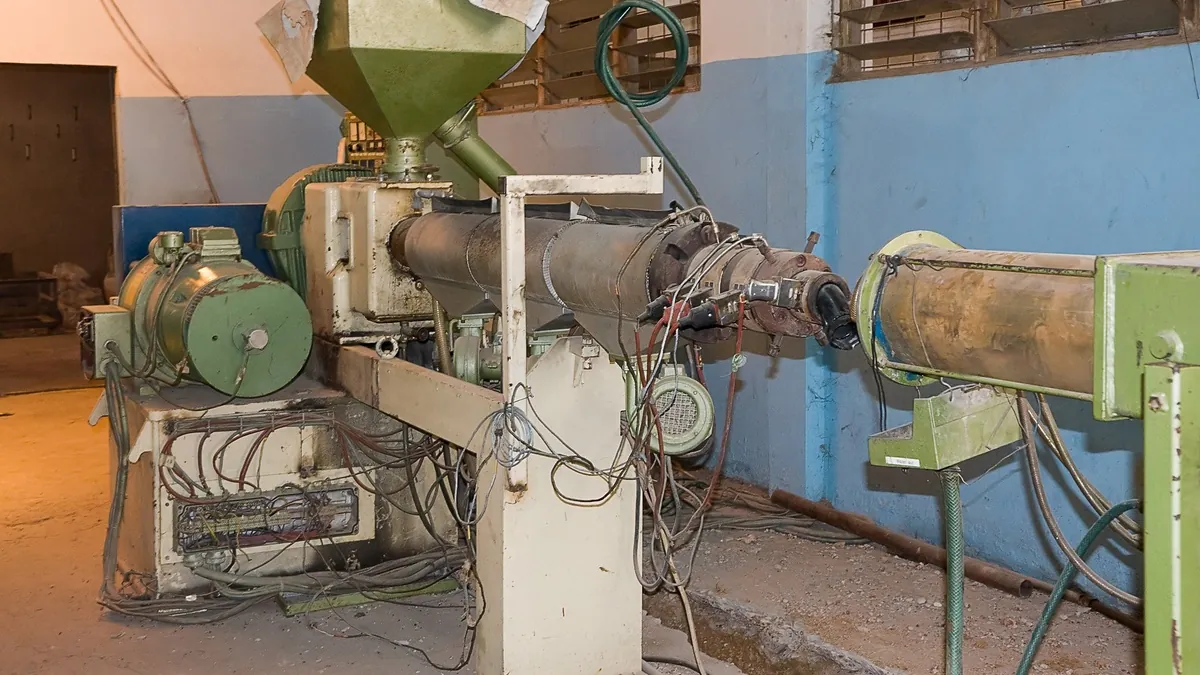 Polymer extrusion line in a production hall, the kind of polymer processing used for ionomers and membranes
