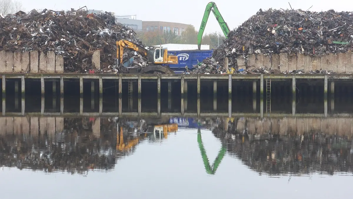 Scrap metal recycling yard with material handler, representing circular recovery of electrolyser metals
