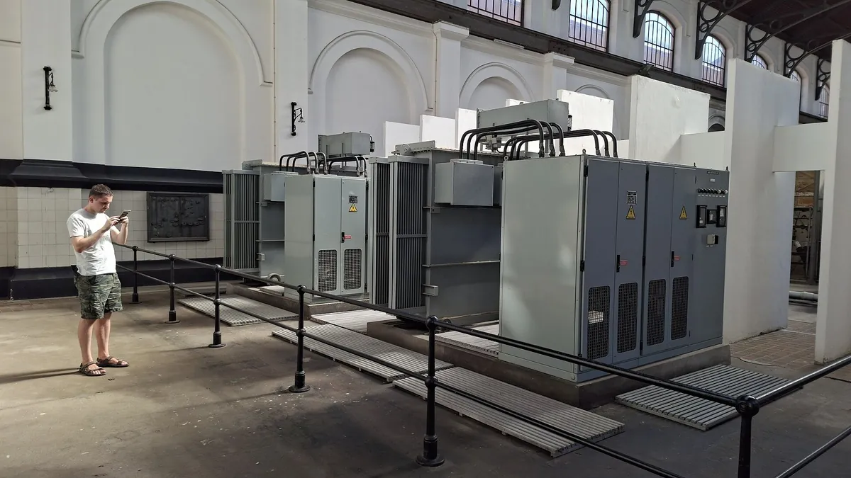 Hall with transformer and semiconductor rectifier cabinets, the power conversion stage inside the electrolyser system boundary